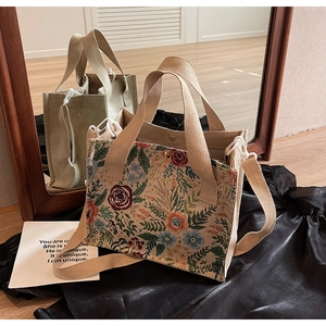 Detailed view of floral jacquard tote bag with canvas straps and crossbody strap detail