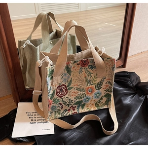 Detailed embroidery on floral linen woven tote bag with a matching adjustable shoulder strap