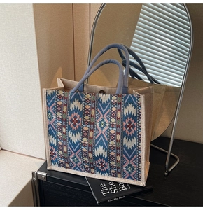 Detail of bohemian geometric pattern on large linen tote bag with braided handles