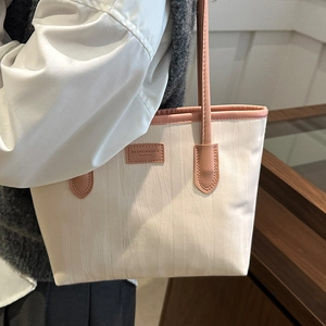 Minimalist cream tote bag with vertical wave embossing and pink leather handles for women