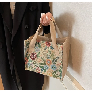 Detail of floral tapestry fabric with vintage patterns and thick woven handles
