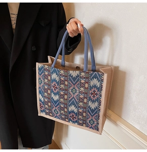 Close-up of ethnic woven linen tote with vintage geometric wave patterns and side button