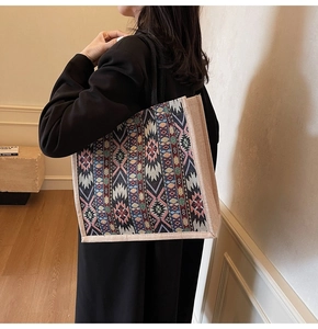Detail view of woven bohemian geometric pattern and natural jute side on tote bag