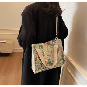 Detailed texture of floral jacquard weave tote bag with secure magnetic closure