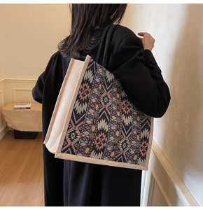 Detailed side view of large linen tote bag with colorful geometric woven pattern