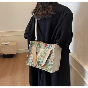 Detailed close-up of floral jacquard tote bag with dual handles and detachable strap