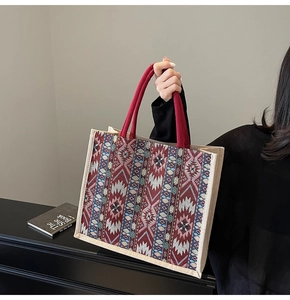 Detail of bohemian tote bag showing geometric patterns and durable red rope handles