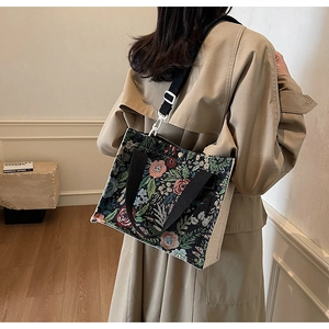 Floral tapestry and linen tote bag detail showing textures and shoulder strap style
