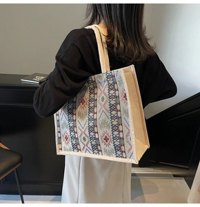 Detail of a large linen tote bag with ethnic geometric patterns and woven texture