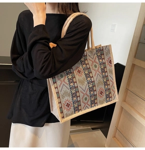 Close-up of ethnic woven pattern and star design on a linen tote bag with sturdy handles