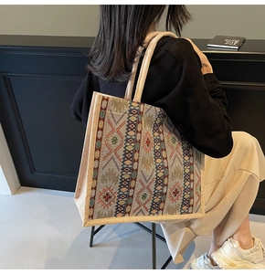 Detail of colorful geometric woven pattern and rope handles on this linen tote bag