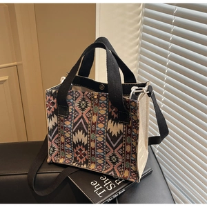 Detail of bohemian ethnic woven patterns and beige canvas on the crossbody tote bag