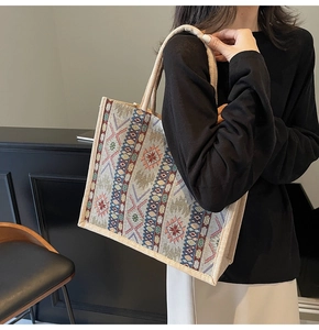 Detailed side view of a large linen tote bag with colorful geometric patterns and handles