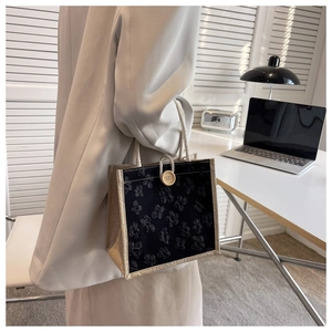 Detail view of floral texture and cotton rope handle with wooden button on linen tote bag