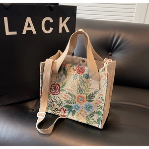 Close-up of floral jacquard linen tote bag with magnetic closure and wide strap