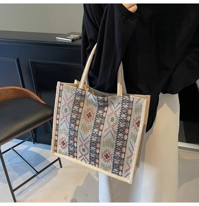 Detail of ethnic geometric pattern and woven handles on a large linen tote bag