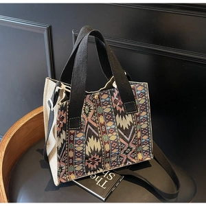 Detailed close-up of woven canvas tote bag with colorful ethnic geometric patterns