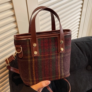 Vintage wool blend plaid bucket bag with brown leather handles and gold metal studs