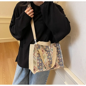 Ethnic geometric woven tote bag with durable canvas handles shown in home setting