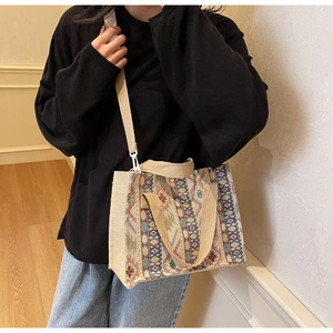 Detail view of ethnic jacquard woven tote bag with adjustable strap and geometric patterns