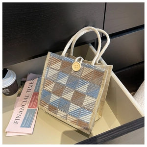 Close-up of linen tote bag with colorful diamond lattice pattern and rope handles