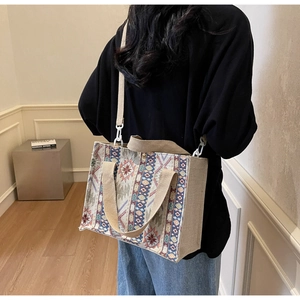 Detailed texture of bohemian woven handbag with colorful geometric patterns and strap