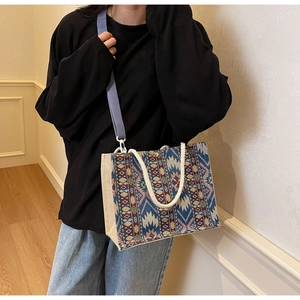 Detail of bohemian woven tote bag with geometric ethnic patterns and wide shoulder strap