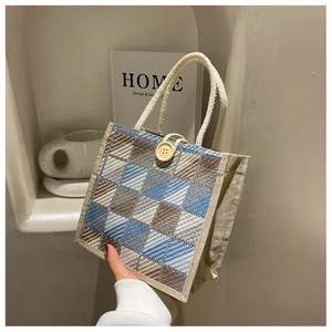 Close-up of minimalist linen handbag with geometric pattern and cotton rope handle