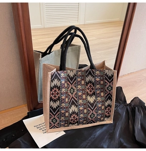 Detailed view of woven geometric patterns and braided handles on a large linen tote bag