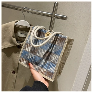 Detail of checkered linen handbag with blue brown pattern and soft cotton rope handle