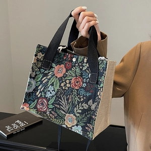 Floral tapestry and natural jute woven tote bag with sturdy black handles for daily use