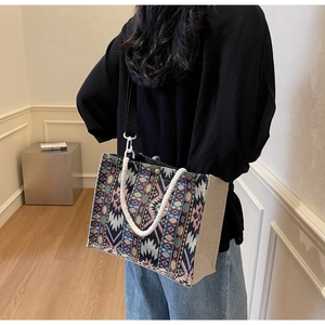 Ethnic woven tote bag featuring geometric patterns and durable braided rope handles
