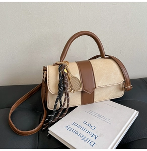Sac à main beige et marron orné d'un pendentif raquette de tennis et cordon tressé
