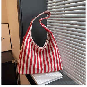 Detail view of red and white striped tote bag showing woven texture on a windowsill