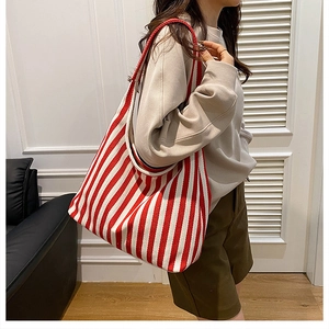 Detail of red and white vertical striped canvas tote bag showing thick texture and large size