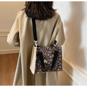 Detailed back view of model wearing a bohemian woven tote bag with canvas side panels