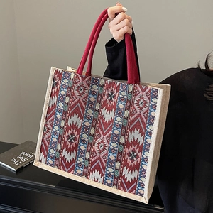 Large linen tote bag with geometric patterns and red handles for daily commuting