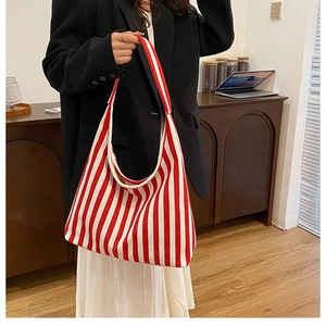 Detailed view of red and white striped tote bag with high-capacity knitted texture