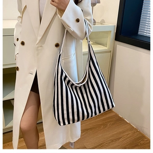 Detailed close-up of large black and white striped canvas tote bag fabric and texture