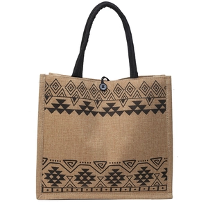 Ethnic woven jute tote bag with black geometric patterns and rope handles
