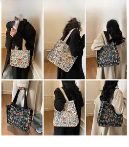 Detailed close-up showing butterfly print canvas tote bag with reinforced black shoulder straps