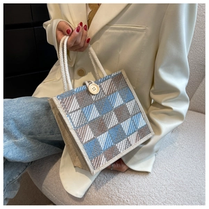 Close-up of linen plaid tote bag with rope handle and decorative button closure