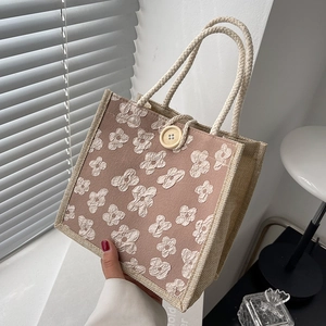 Beige linen tote bag with 3D floral relief pattern and braided cotton rope handles