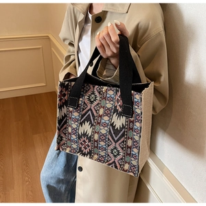 Close-up of ethnic woven handbag with colorful geometric patterns and flax side detail