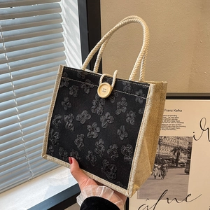 Handheld vintage linen tote bag with black floral jacquard and large wooden button