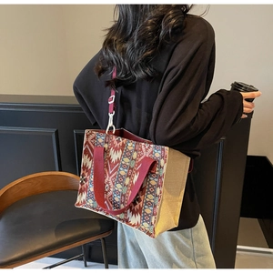 Detailed side view of woven ethnic tote bag with colorful patterns and linen side panel