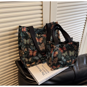 Detail of vintage butterfly jacquard tote bags in two sizes with woven fabric textures