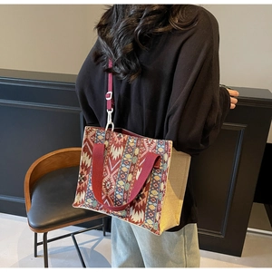 Detailed back view of a colorful ethnic woven crossbody bag with geometric patterns