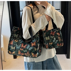 Detail of large and small tote bags featuring a vibrant colorful butterfly pattern
