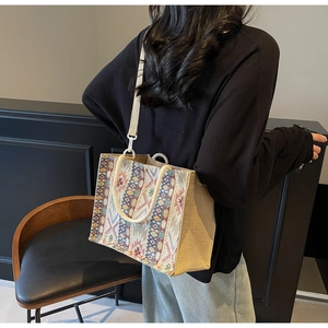 Detailed back view of a woven tote bag with colorful geometric patterns and cotton handles
